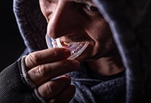 Athlete using mouthguard to protect teeth and dental implants
