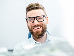 patient smiling after getting a dental bridge in Marshall 