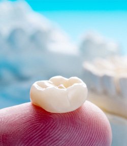 Close-up of dental crown in Marshall, TX on finger  