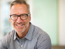 smiling man with dental bridge in Marshall