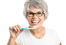 Woman brushing her new dental implant in Marshall