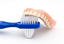 A denture and a toothbrush