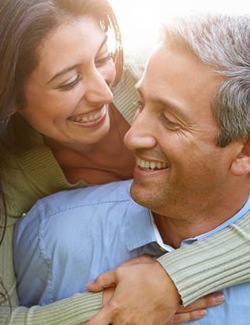 An older woman and man hugging and smiling