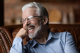 Man with dentures laughing