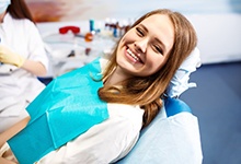 Happy dental patient saving money through regular preventive care