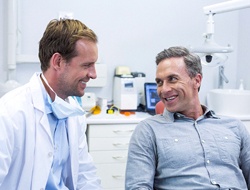 Dentist and patient discussing plan for dental implant salvage