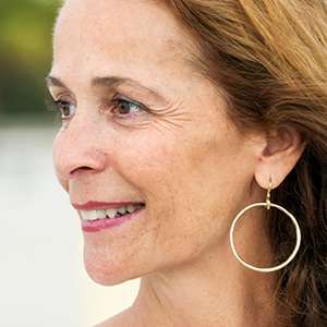 woman with earrings on smiling