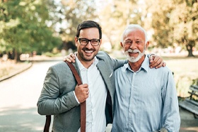 Young man and older man enjoying dental implants