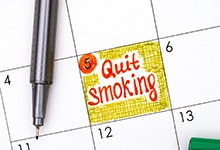 Red and yellow “quit smoking” reminder marked on calendar