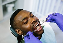Man attending dental checkup to monitor dental implants
