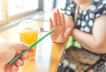 Woman saying no to straw after implant surgery