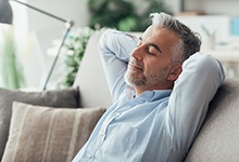 Man resting at home after dental implant surgery