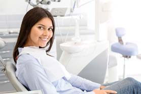 Woman sitting up smiling after oral conscious sedation in Marshall, TX