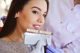 Woman smiling during veneers consultation with cosmetic dentist in Marshall