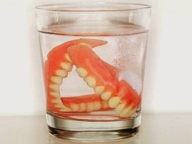 dentures in glass of water